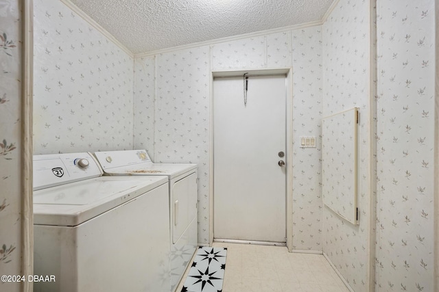 washroom with independent washer and dryer, ornamental molding, and a textured ceiling