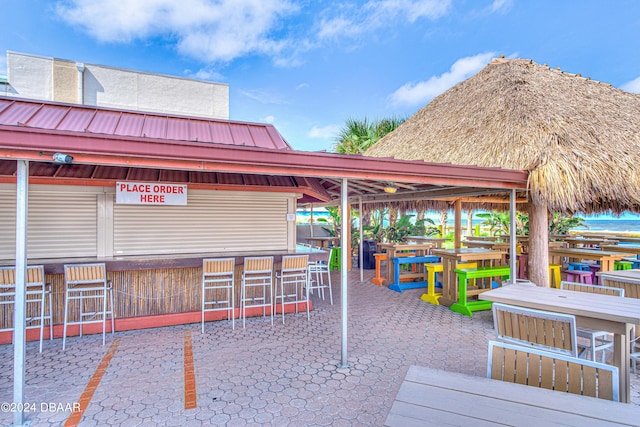 view of property's community with an outdoor bar and a patio