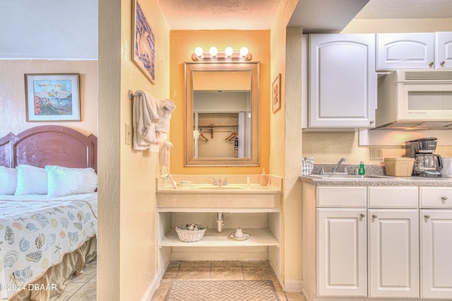 bathroom with tile patterned flooring and vanity