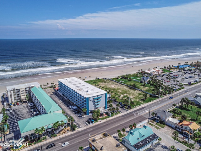 birds eye view of property featuring a beach view and a water view