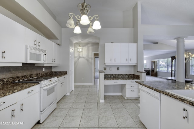 438 Harbour Town Ln, Ormond Beach, FL 32174 - kitchen with white appliances, a chandelier, decorative backsplash, and white cabinetry