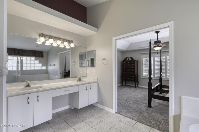 438 Harbour Town Ln, Ormond Beach, FL 32174 - bathroom with double vanity, tile patterned floors, ceiling fan, and baseboards