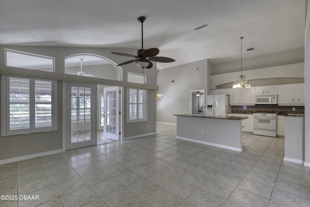 438 Harbour Town Ln, Ormond Beach, FL 32174 - kitchen featuring white appliances, open floor plan, light tile patterned floors, a ceiling fan, and white cabinetry