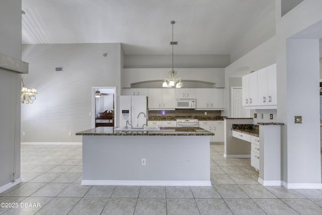 438 Harbour Town Ln, Ormond Beach, FL 32174 - kitchen featuring white appliances, a chandelier, light tile patterned flooring, a sink, and high vaulted ceiling