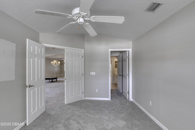 438 Harbour Town Ln, Ormond Beach, FL 32174 - unfurnished bedroom with lofted ceiling, carpet flooring, a textured ceiling, a chandelier, and baseboards