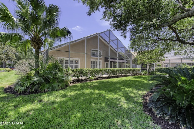 438 Harbour Town Ln, Ormond Beach, FL 32174 - rear view of property featuring stucco siding and a lawn