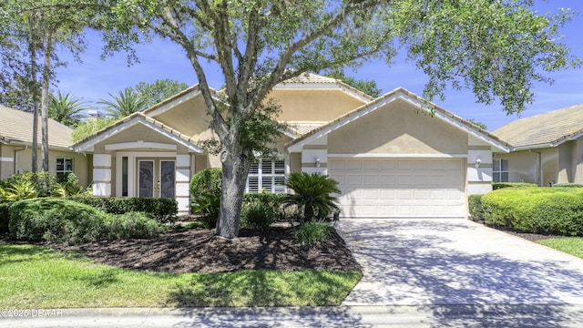 438 Harbour Town Ln, Ormond Beach, FL 32174 - view of front of property featuring an attached garage, stucco siding, driveway, and french doors