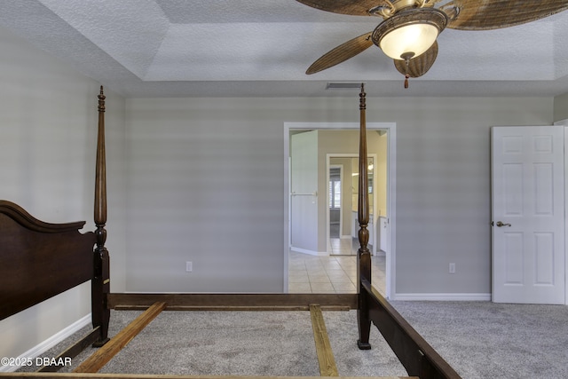 438 Harbour Town Ln, Ormond Beach, FL 32174 - carpeted bedroom featuring a textured ceiling, a ceiling fan, and baseboards
