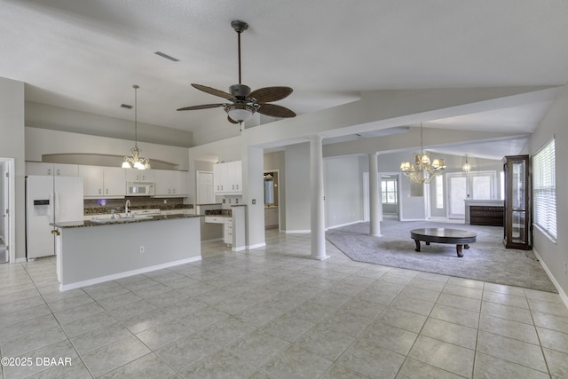 438 Harbour Town Ln, Ormond Beach, FL 32174 - unfurnished living room featuring vaulted ceiling, a chandelier, light tile patterned floors, ceiling fan, and baseboards