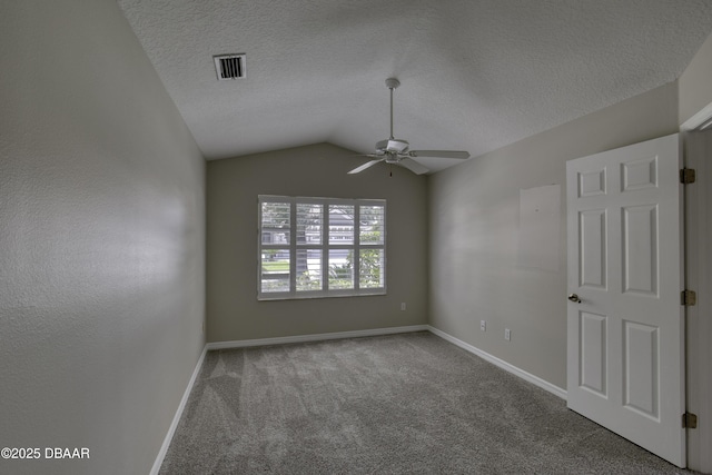 438 Harbour Town Ln, Ormond Beach, FL 32174 - empty room featuring ceiling fan, carpet floors, baseboards, lofted ceiling, and a textured ceiling