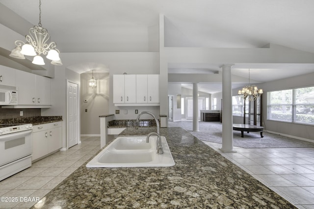 438 Harbour Town Ln, Ormond Beach, FL 32174 - kitchen featuring a chandelier, white appliances, a sink, light tile patterned flooring, and lofted ceiling