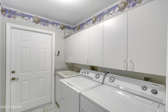 438 Harbour Town Ln, Ormond Beach, FL 32174 - washroom with washing machine and clothes dryer, cabinet space, a textured ceiling, and light tile patterned flooring