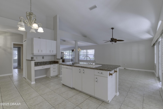 438 Harbour Town Ln, Ormond Beach, FL 32174 - kitchen with a sink, dishwasher, light tile patterned flooring, vaulted ceiling, and an island with sink