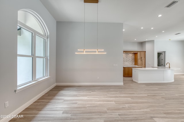 interior space with light hardwood / wood-style floors and sink