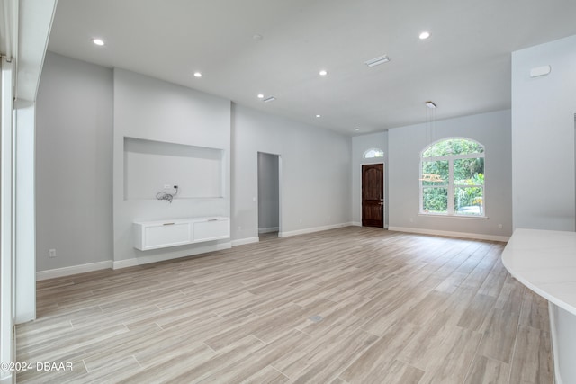 unfurnished living room featuring light wood-type flooring