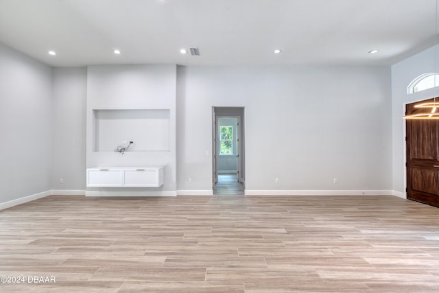 unfurnished living room with light wood-type flooring