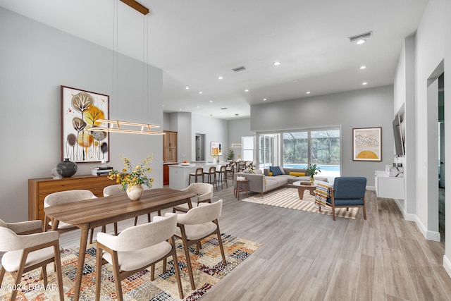 dining space with light hardwood / wood-style flooring