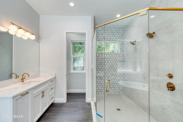 bathroom featuring walk in shower, vanity, and hardwood / wood-style flooring