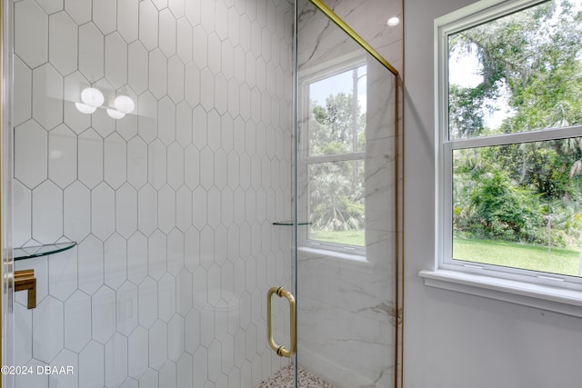 bathroom featuring a shower with door