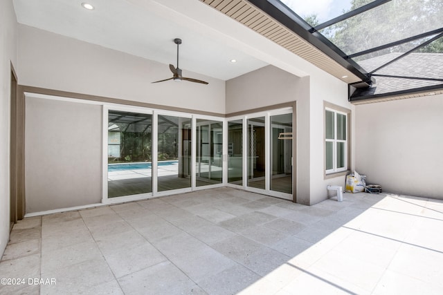 view of patio / terrace with glass enclosure and ceiling fan