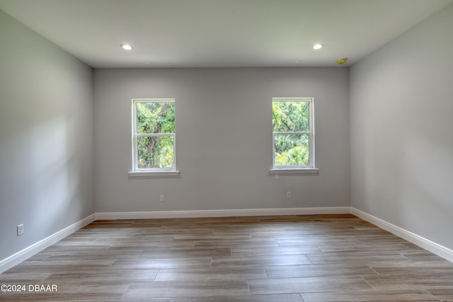 spare room with plenty of natural light and light hardwood / wood-style floors