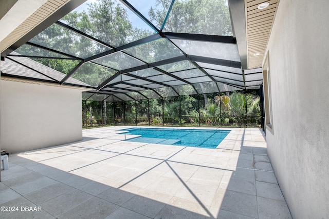 view of pool featuring a lanai and a patio