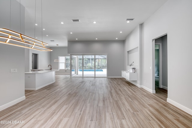 unfurnished living room with light hardwood / wood-style flooring