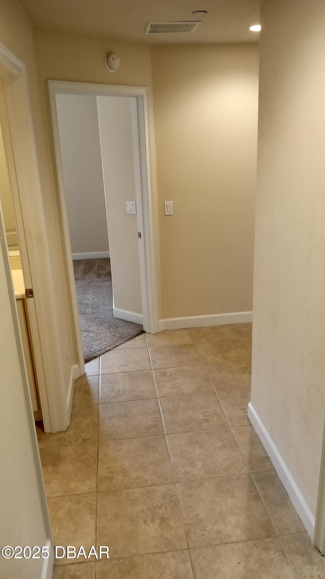 hallway with light tile patterned floors