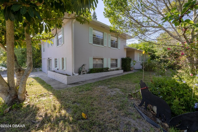 view of side of property with a yard