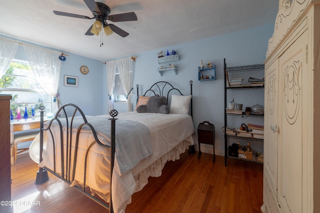 bedroom with hardwood / wood-style floors and ceiling fan