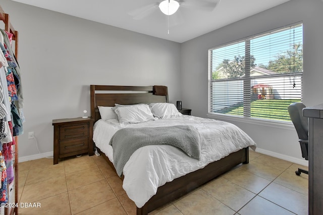 bedroom featuring light tile patterned floors and ceiling fan