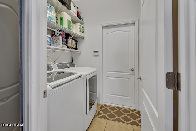 laundry room featuring light tile patterned floors and separate washer and dryer