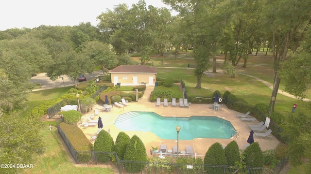 view of pool featuring a patio area and a lawn