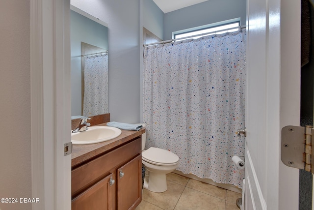 bathroom with toilet, vanity, a shower with shower curtain, and tile patterned flooring