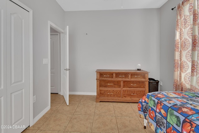 tiled bedroom featuring a closet