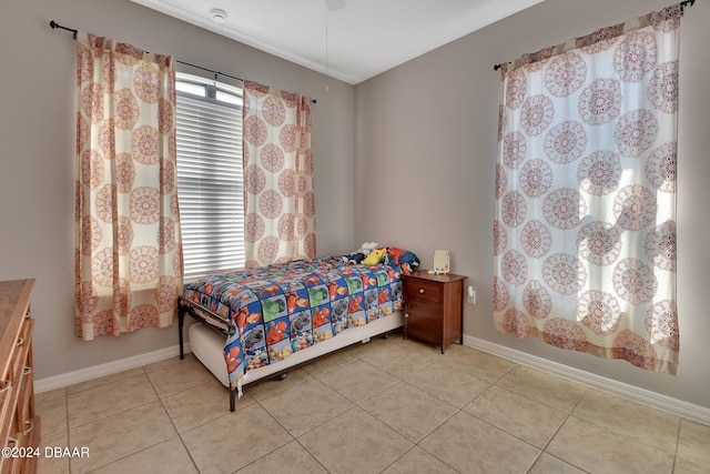 bedroom featuring light tile patterned floors and ceiling fan