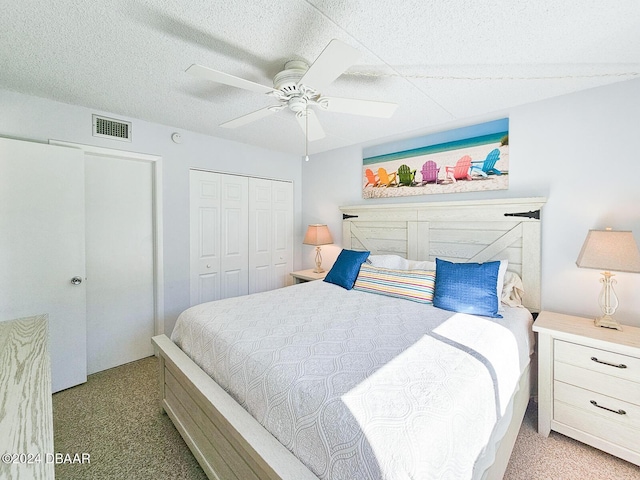 100 Silver Beach Ave Unit 118, Daytona Beach, FL 32118 - carpeted bedroom featuring a closet, a ceiling fan, and a textured ceiling