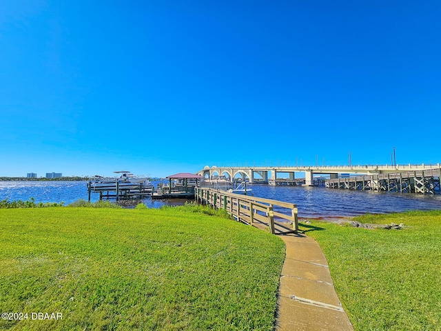 100 Silver Beach Ave Unit 118, Daytona Beach, FL 32118 - dock area with a water view and a lawn