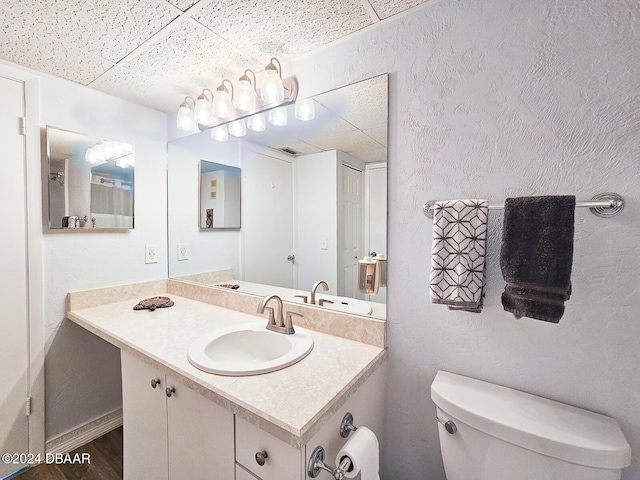 100 Silver Beach Ave Unit 118, Daytona Beach, FL 32118 - bathroom featuring vanity, a paneled ceiling, and a textured wall