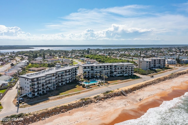 birds eye view of property with a view of the beach and a water view