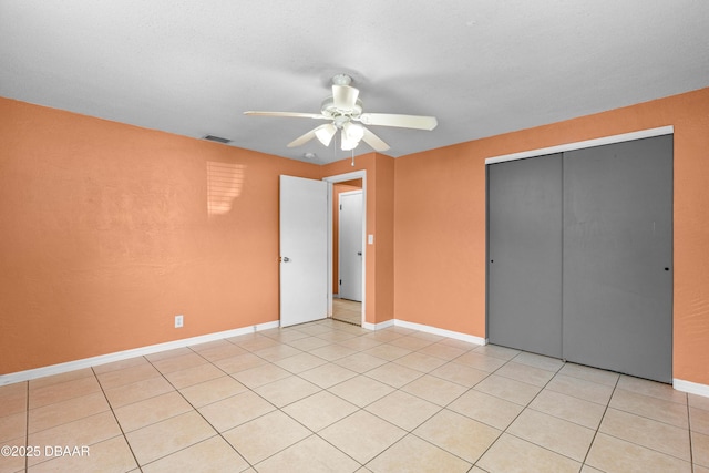 1572 Primrose Ln, Daytona Beach, FL 32117 - unfurnished bedroom featuring a closet, light tile patterned flooring, ceiling fan, and baseboards
