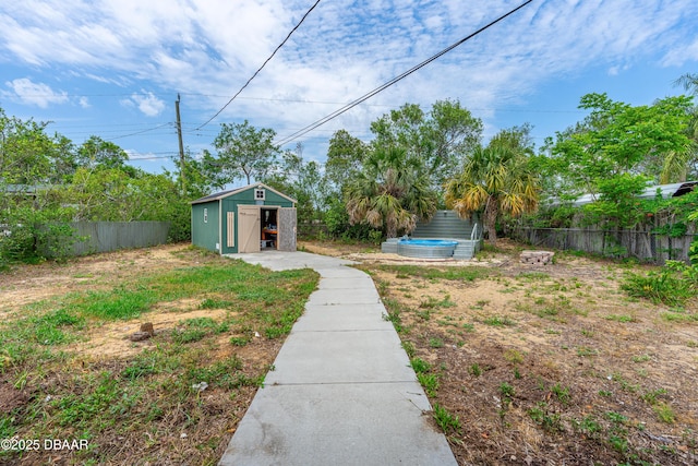 1572 Primrose Ln, Daytona Beach, FL 32117 - view of yard featuring fence, a storage shed, and an outdoor structure