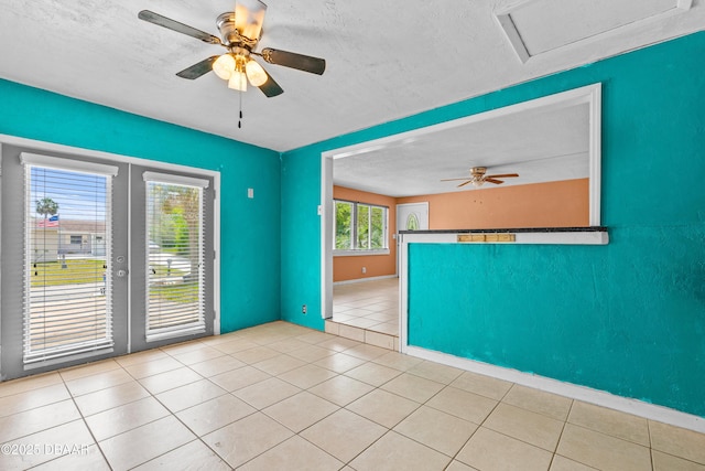 1572 Primrose Ln, Daytona Beach, FL 32117 - unfurnished room featuring ceiling fan, french doors, a textured ceiling, tile patterned floors, and attic access