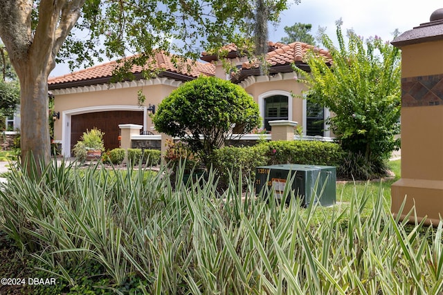 mediterranean / spanish-style home featuring a garage