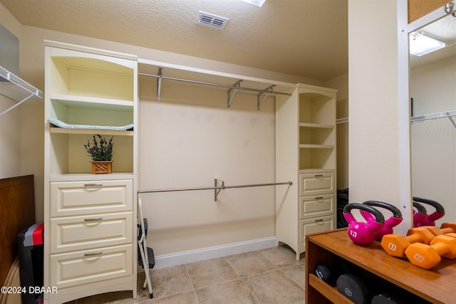 walk in closet featuring light tile patterned floors