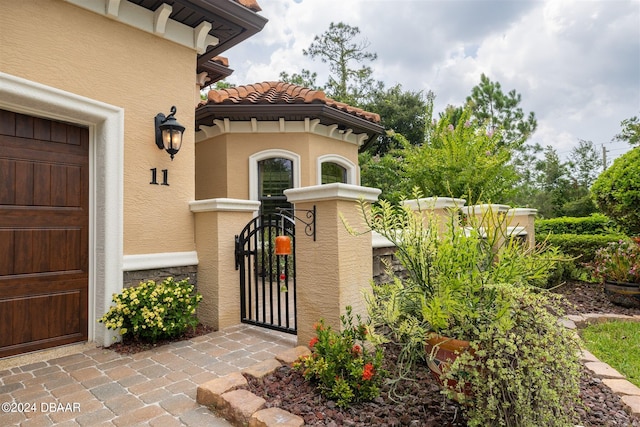 view of exterior entry featuring a garage