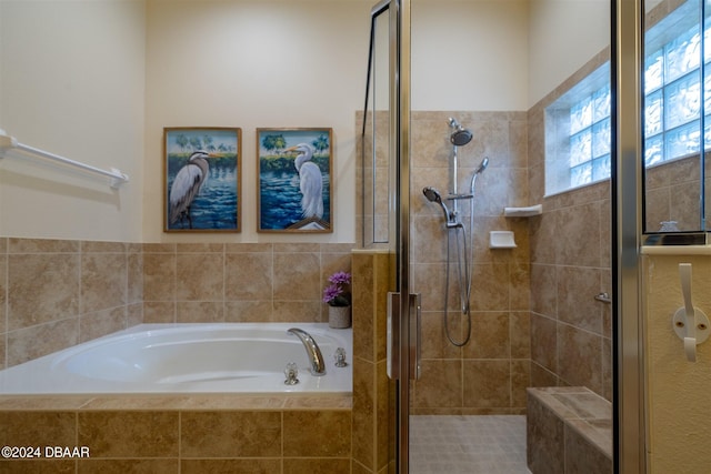 bathroom featuring independent shower and bath