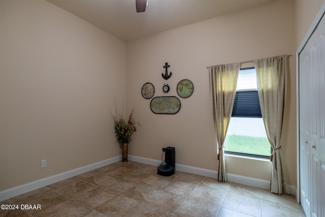 empty room featuring ceiling fan and light tile patterned flooring