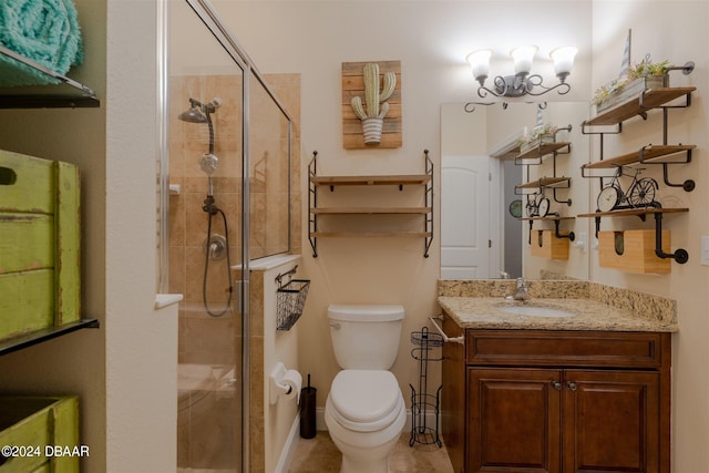 bathroom featuring a shower with door, vanity, and toilet