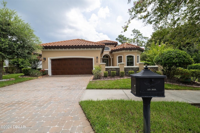 mediterranean / spanish home featuring a garage